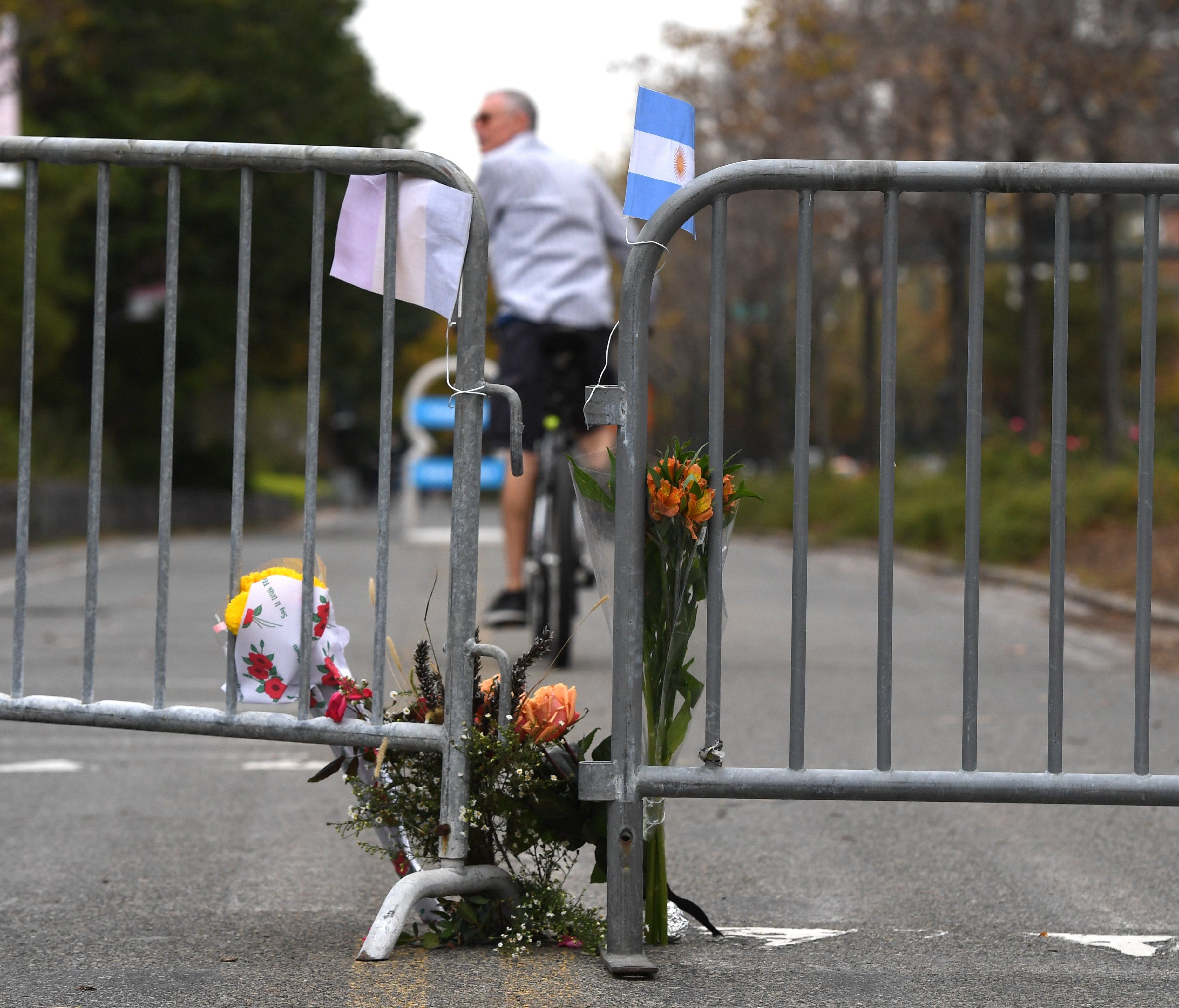 People stop at a memorial Nov. 1, 2017, near the site of a terror attack in New York.  The pickup truck driver who plowed down a New York cycle path, killing eight people, in the city's worst attack since September 11, was associated with the Islamic 