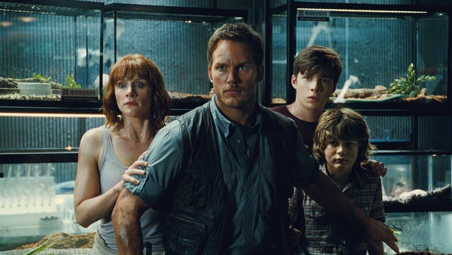 This photo provided by Universal Pictures shows, Bryce Dallas Howard, from left, as Claire, Chris Pratt as Owen, Nick Robinson as Zach, and Ty Simpkins as Gray, in a scene from the film, "Jurassic World," directed by Colin Trevorrow, in the next installment of Steven Spielberg's groundbreaking "Jurassic Park" series. The Universal Pictures 3D movie releases in theaters on June 12, 2015. (Universal Pictures/Amblin Entertainment via AP)