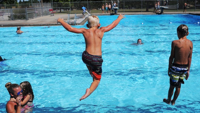 Asher Vandewater, 6, left, and Joah Vandewater, 8, both of Sioux Falls, jump into the pool on Tuesday, Aug. 11, 2015, at the Kuehn Park Pool in Sioux Falls. All but two Sioux Falls pools--the Kuehn Park pool and the Terrace Park Family Aquatic Center--will close by Aug. 23. The pools at Terrace and Kuehn parks will be open through Sept. 6. 