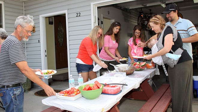 Tony Boatman, Brittany Sullivan, Julie and Sienna Ellingson, and Chad and Mistina Leitheiser, residents of Rose Court in Windsor, take part in 2014 National Night Out festivities. 
 Carol Hirata/For the Beacon