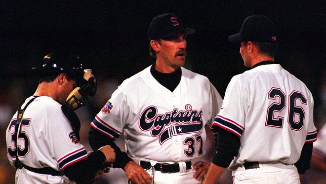 Former Shreveport Captains pitching coach Todd Oakes (37) speaks to pitcher Jason Grilli (26) and Frank Charles (35) during a Texas League baseball game.