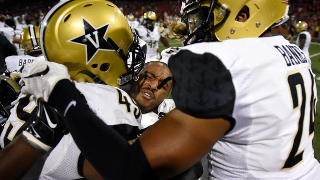Vanderbilt University cornerback Taurean Ferguson (3) is hugged by teammates after they defeated Western Kentucky University 31-30 in an NCAA college football game, Saturday, Sept. 24, 2016, in Bowling Green, Ky.
