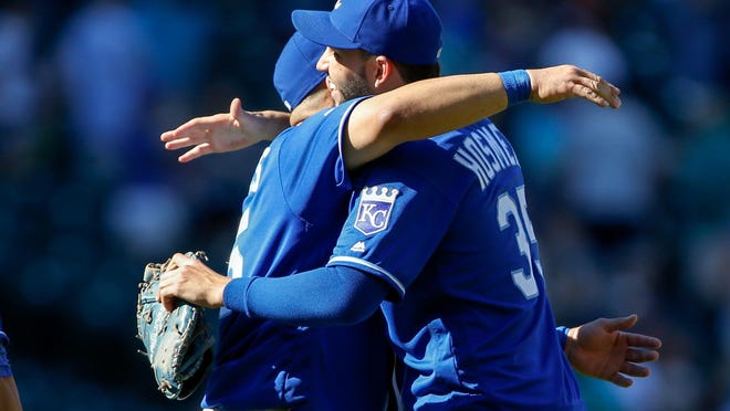 Royals designated hitter Kendrys Morales (left) hugs first baseman Eric Hosmer (right) after a game against the Seattle Mariners at Safeco Field. Kansas City won 4-1.