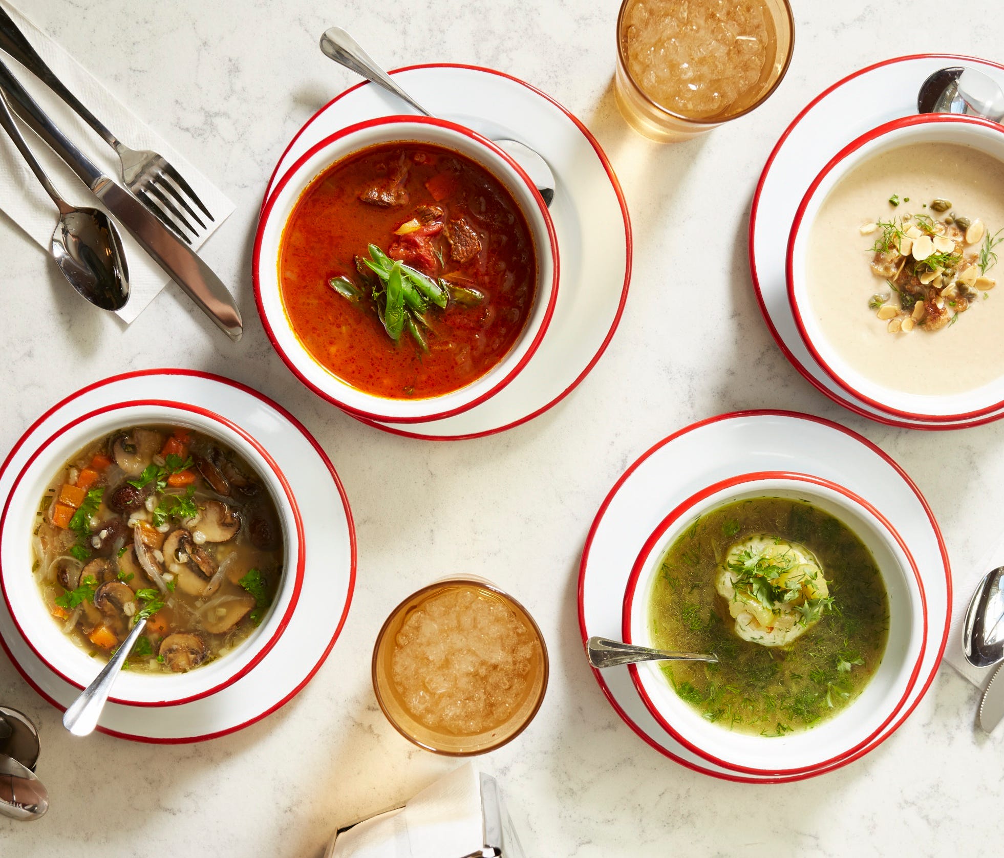 The menu at Rooster Soup Co. includes such choices as (from left to right) mushroom barley, beef and vegetable, smoked matzo ball and roasted cauliflower soups.