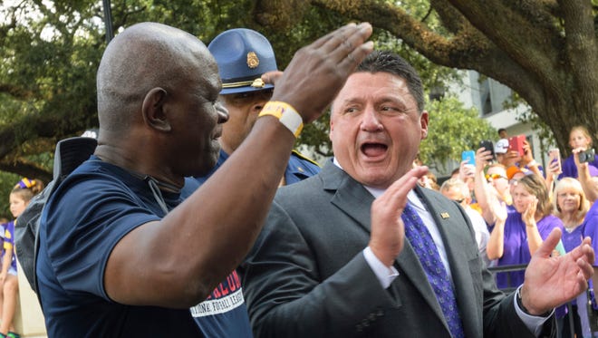 LSU head coach Ed Orgeron, right, greets LSU alumni before an NCAA college football game against Troy in Baton Rouge, La., Wednesday, Sept. 30, 2017.