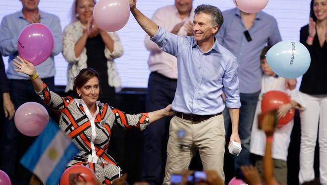 Argentine opposition presidential candidate Mauricio Macri and vice presidential candidate Gabriela Michetti celebrate with supporters at the campaign headquarters in Buenos Aires Nov. 22, 2015.