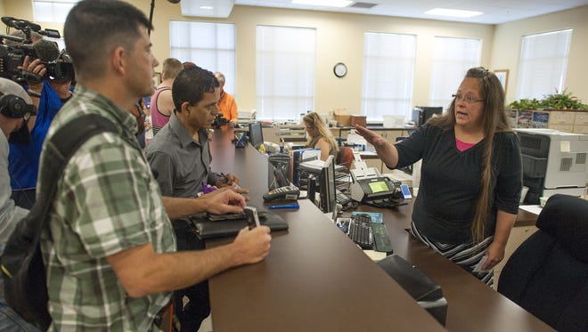 Robbie Blankenship stands next to his partner of 20 years, Jesse Cruz, of Corpus Christie, Texas, as they speak with Rowan County Clerk of Courts Kim Davis at the County Clerks Office on September 2, 2015 in Morehead, Ky. Citing a sincere religious objection, Davis, an Apostolic Christian, has refused to issue marriage licenses to same sex couples in defiance of a Supreme Court ruling.