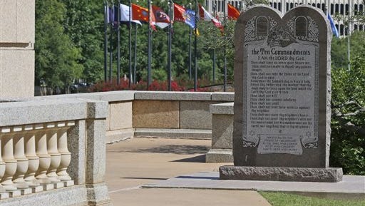 FILE - In this Tuesday, June 30, 2015 file photo, the Ten Commandments Monument is pictured at the state Capitol in Oklahoma City, Okla. The Oklahoma Supreme Court’s June 30 decision to order the monument removed from the state Capitol grounds has so angered conservatives in the Legislature that some Republicans are calling for justices to be impeached.