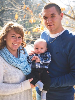 Howard County Sheriff's Deputy Carl A. Koontz with his wife, Kassie, and son, Noah.