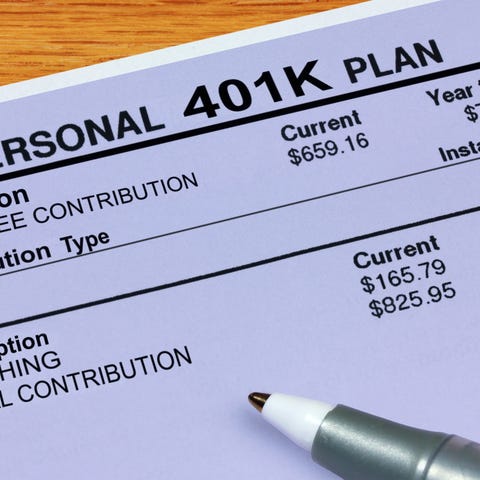 Pen resting on 401(k) plan statement