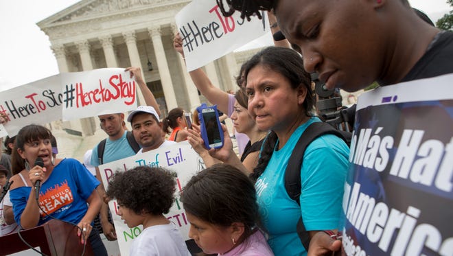 Families react to news on a Supreme Court decision blocking Obama's immigration plan, which would have protected millions of immigrants from deportation, in front of the Supreme Court on June 23, 2016.