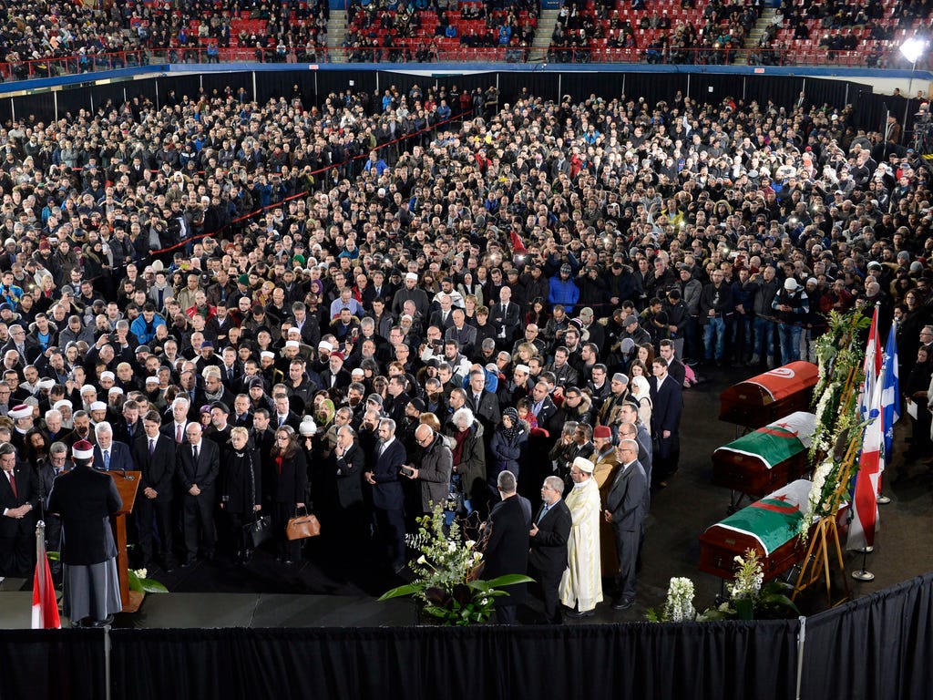 Mourners attend the funeral for Abdelkrim Hassane, Khaled Belkacemi and Aboubaker Thabti, three of the six victims of Sunday's Quebec City mosque shooting, at the Maurice Richard Arena in Montreal on Feb. 2, 2017.