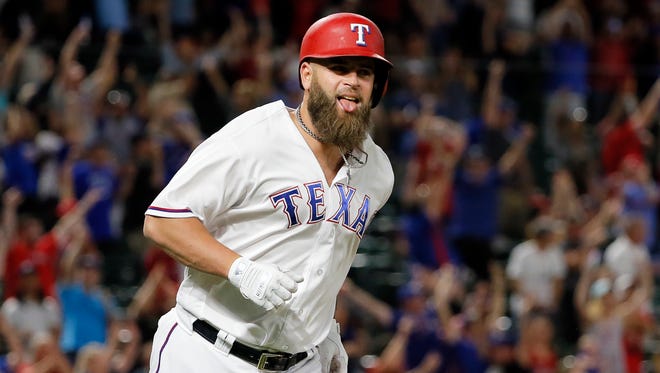Texas Rangers' Mike Napoli celebrates as he runs the bases after hitting a game-winning three-run home run off San Diego Padres reliever Brandon Maurer during the ninth inning of a baseball game, Thursday in Arlington, Texas.