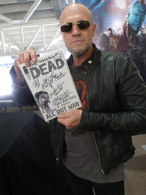 Michael Rooker, who played Merle Dixon on "The Walking Dead," holds an autographed copy of "The Walking Dead" comic book, issue #115.
