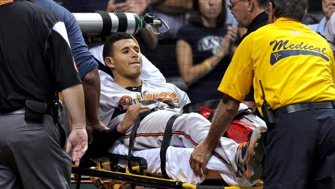Orioles third baseman Manny Machado is taken off the field on a stretcher after injuring his left leg against the Rays.