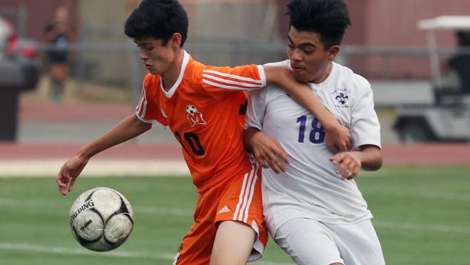 From left, Mamaroneck's Liam O'Reilly (10) controls the ball in front of New Rochelle's Juan Torres (18) during boys soccer action at New Rochelle High School Oct. 1, 2017.  Mamaroneck won the game 1-0.