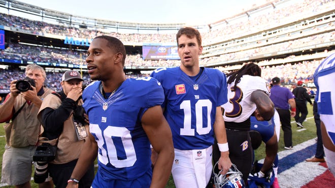 New York Giants wide receiver Victor Cruz (80) and New York Giants quarterback Eli Manning (10) after the game.