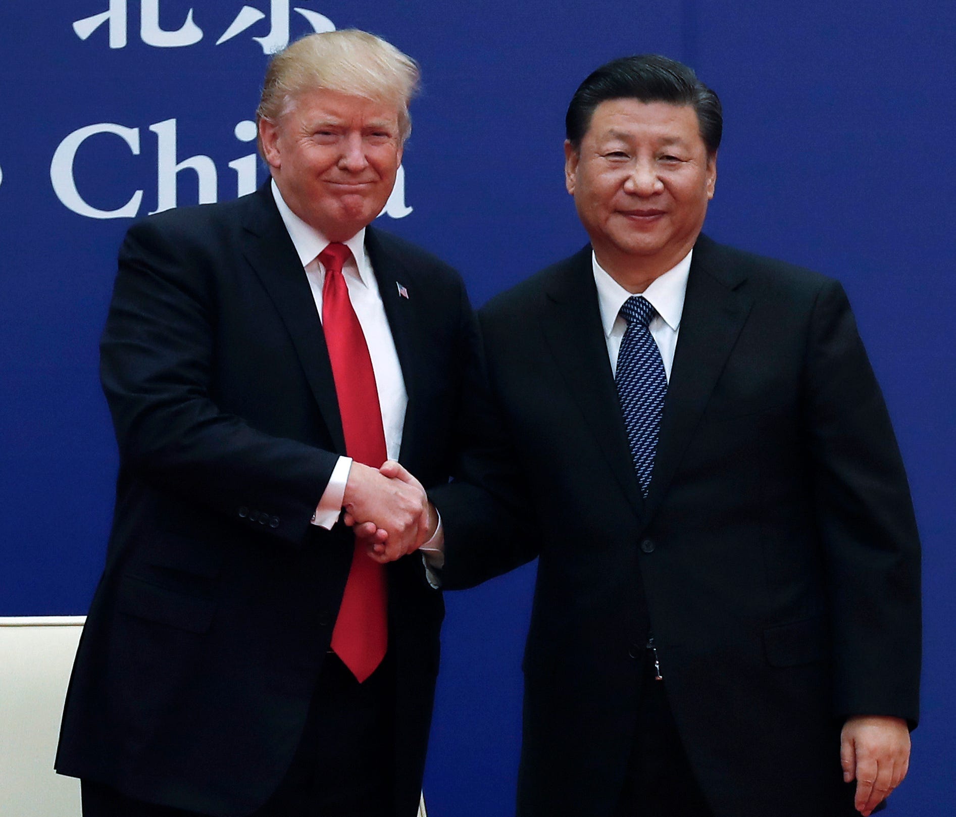 U.S. President Donald Trump, left, shakes hands with Chinese President Xi Jinping during a business event at the Great Hall of the People in Beijing on Nov. 9, 2017.