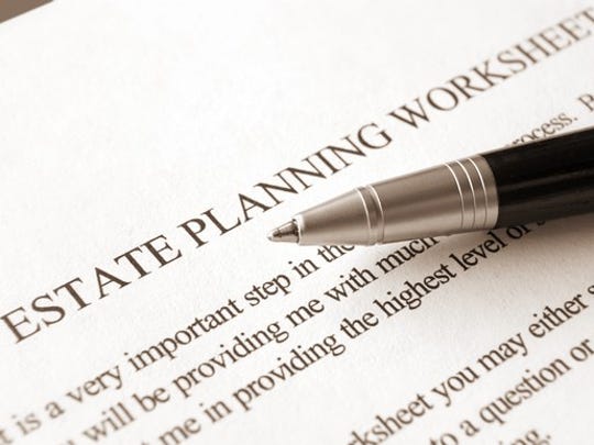 Paper labeled estate planning worksheet with instructions, and a pen on top.