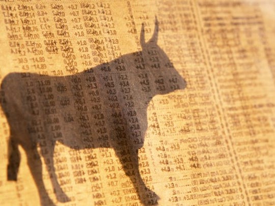 Shadow of a stock market bull over a background of stock prices