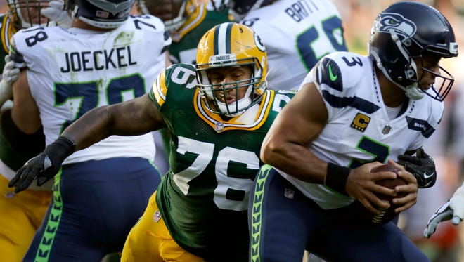 Packers defensive end Mike Daniels closes in to sack Seahawks quarterback Russell Wilson.