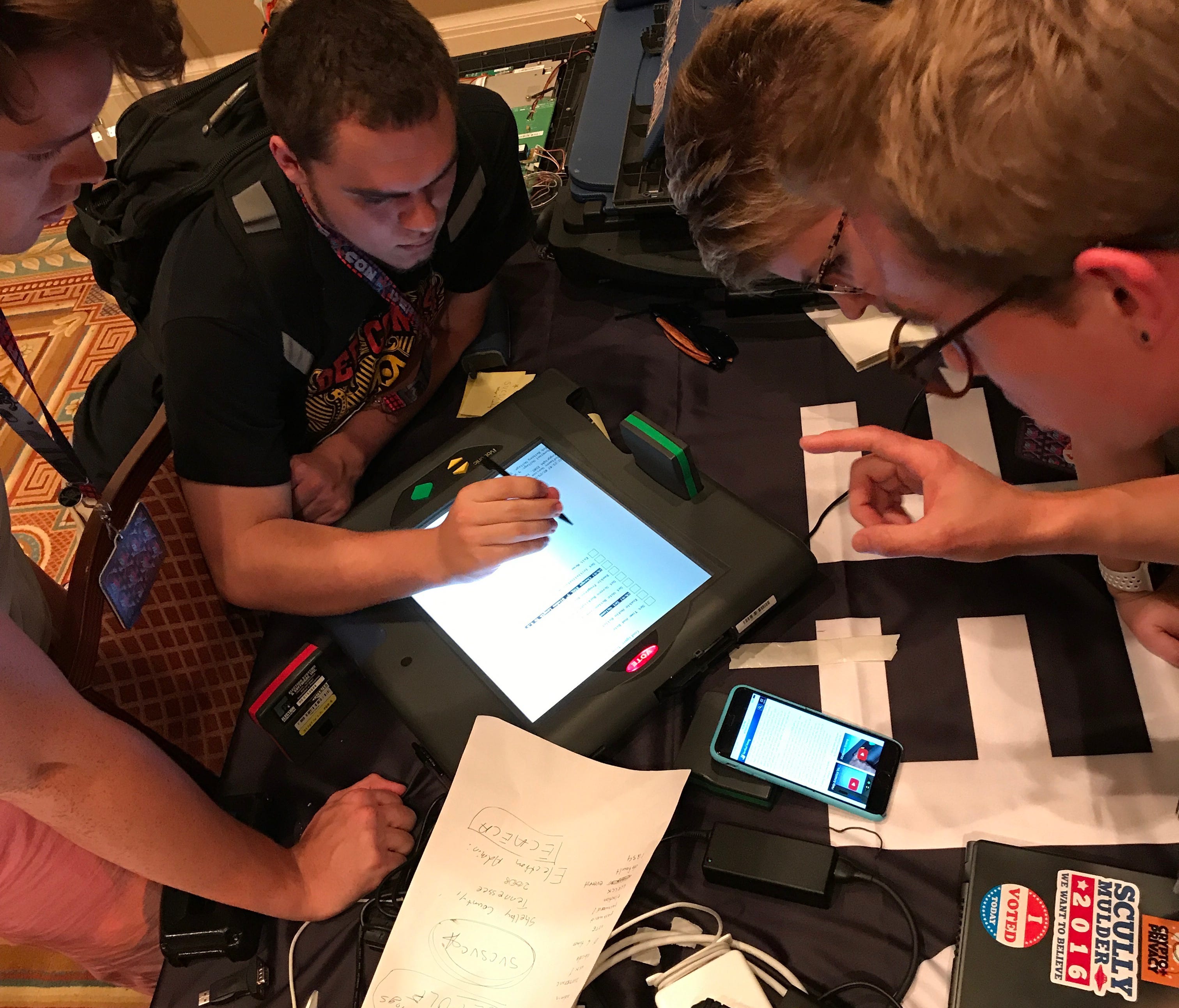 A group of hackers at the DefCon computer security conference in Las Vegas attempt to (legally) break in to a touch screen voting machine. The effort was part of a weekend-long  Voting Machine Hacking Village at the conference aimed at raising awaren