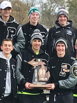 The Plymouth boys cross country team celebrates its first regional title in school history.