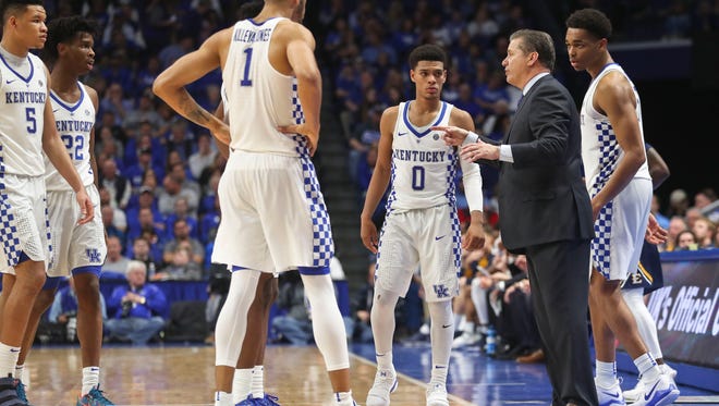 Kentucky head coach John Calipari talks with his team in the second half Friday night at Rupp Arena. The Wildcats won 78-61 after a sluggish start early in the first half. "I would tell our fans, just enjoy this, because I'm the one dying," said Calipari afterwards.