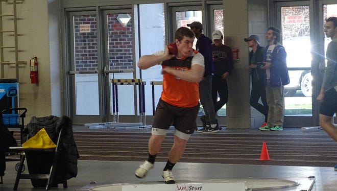 Heath senior Kyle Yoho competes in the shot put Sunday during the Division II-III Central District Indoor meet at Capital University. Yoho is qualified to the indoor state meet in the weight throw.