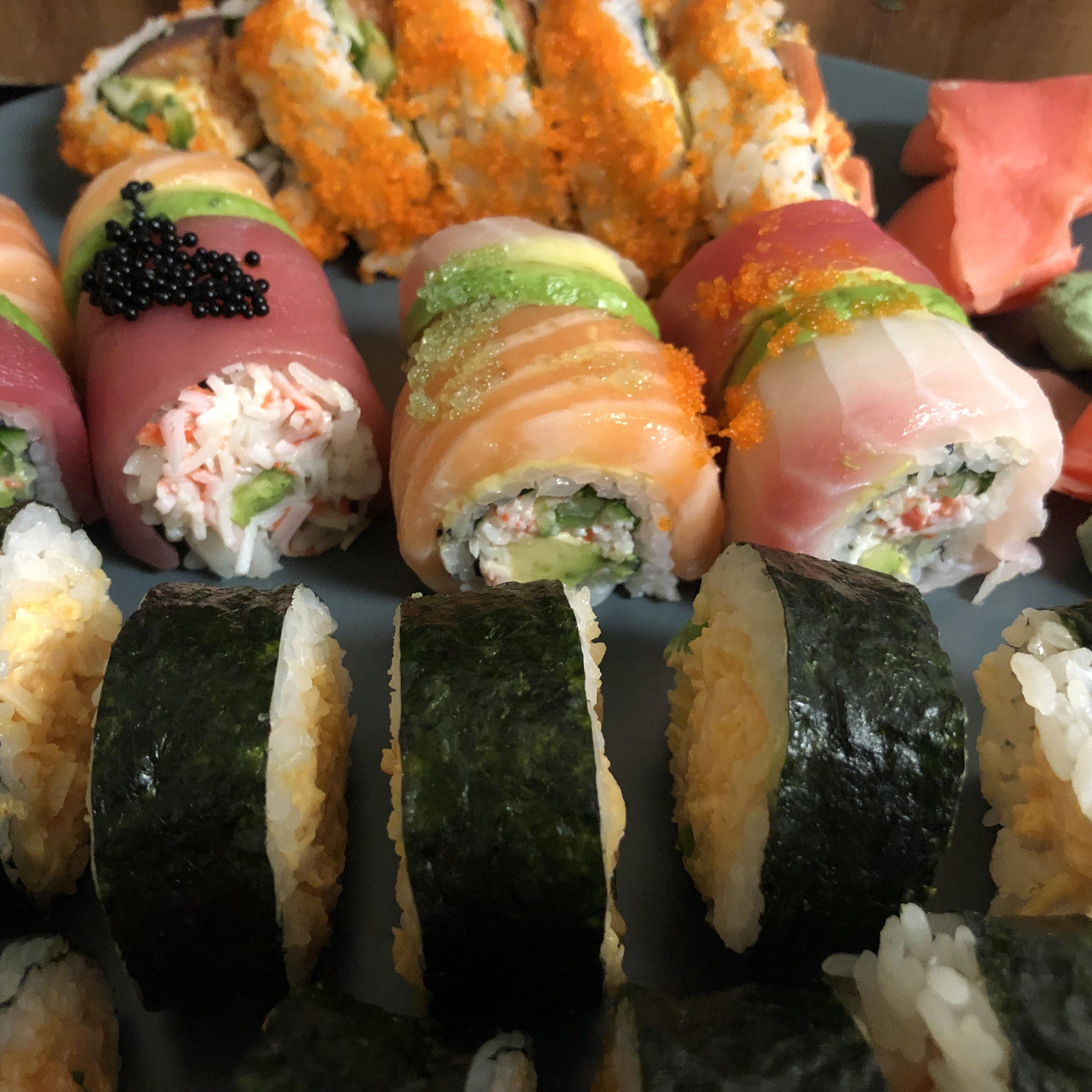 A recent Sushigawa order included spicy salmon and spicy scallop rolls (front row), plus Rainbow maki and a 1/2 Crazy roll.