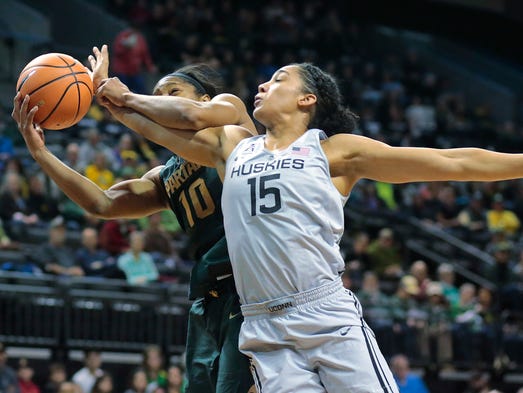 Michigan State's Branndais Agee (10) is fouled by Connecticut's
