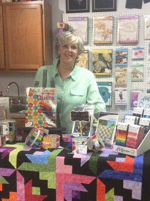 Marsha Cowan displays some of the training materials available at Bernina Sewing and Design, 1601 E. Lohman Dr.