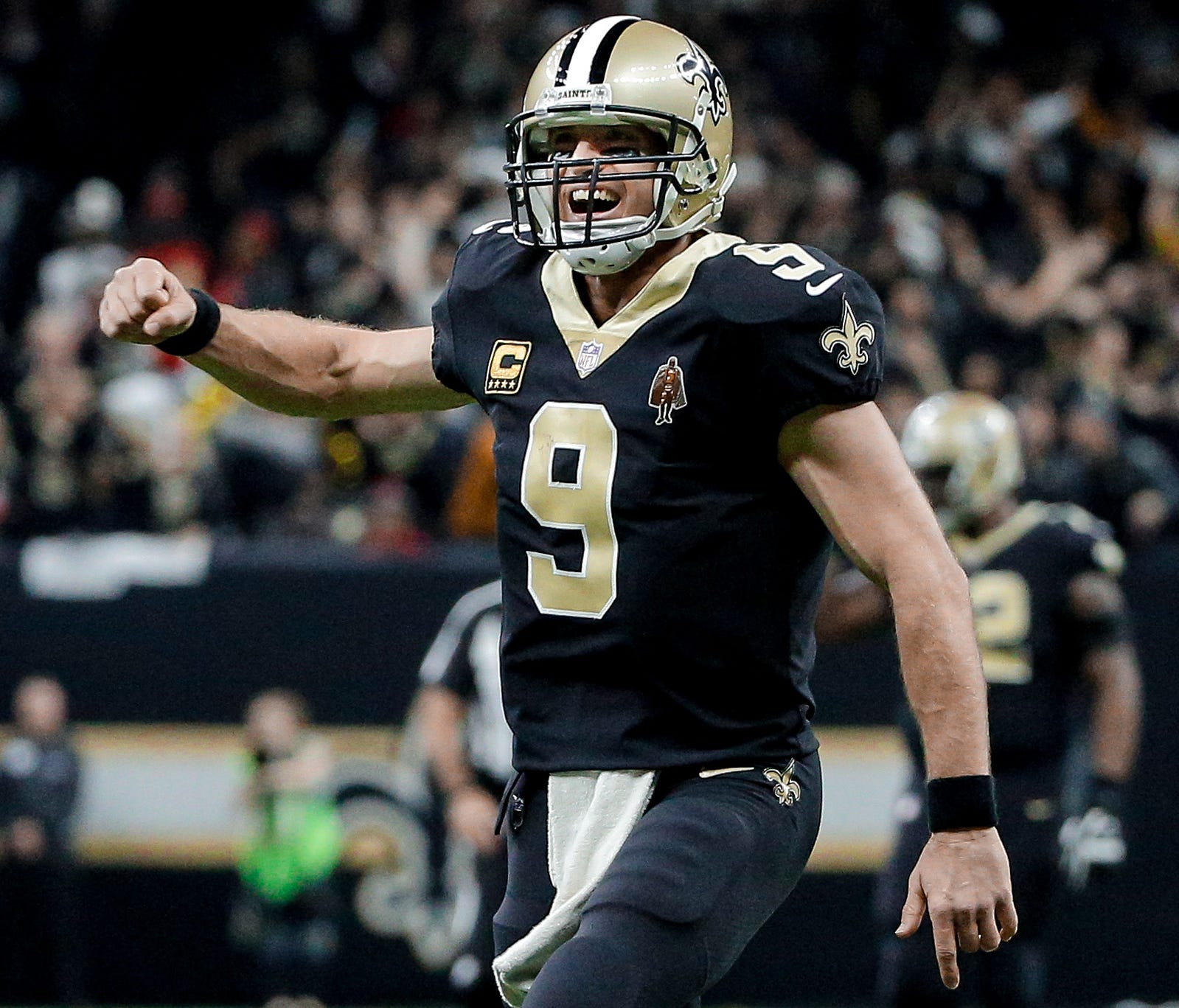 New Orleans Saints quarterback Drew Brees (9) celebrates after throwing a touchdown to wide receiver Ted Ginn during the second quarter against the Atlanta Falcons at the Mercedes-Benz Superdome.