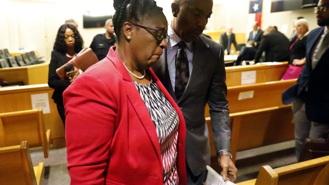 Botham Jean's mother, Allison Jean, leaves the courtroom following closing arguments in the murder trial of fired Dallas Police Officer Amber Guyger, Monday, Sept. 30, 2019, in Dallas. Guyger shot and killed Botham Jean, an unarmed 26-year-old neighbor in his own apartment in September 2018. She told police she thought his apartment was her own and that he was an intruder. (Tom Fox/The Dallas Morning News via AP, Pool)