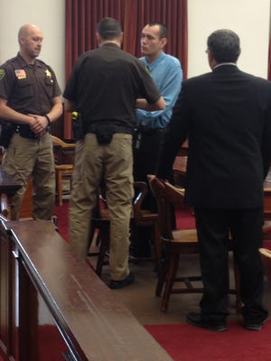 Garrett Whitegrass is handcuffed by sheriff's deputies after a jury found him guilty of rape.