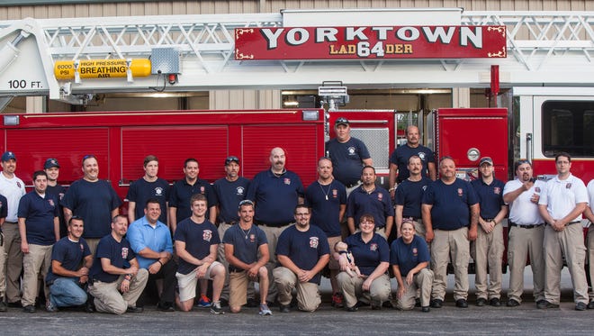 The Yorktown Fire Department stands with the new aerial truck.