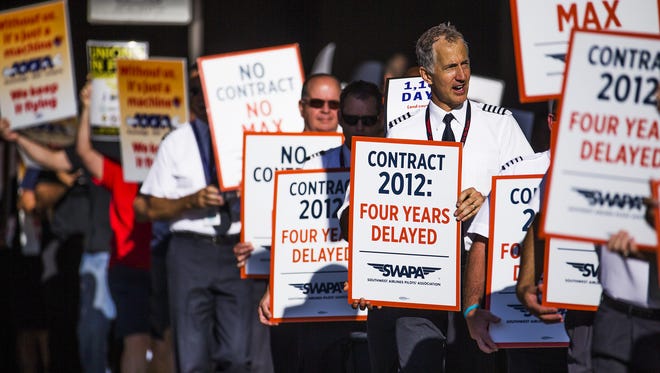 Employees of Southwest Airlines picket outside Terminal 4 at Sky Harbor International Airport, Monday, August 8, 2016.  Employees are frustrated by the lack of a new contract.