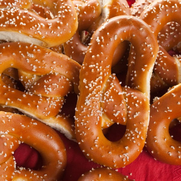 pennsylvania dutch soft pretzels rest on a red plate
