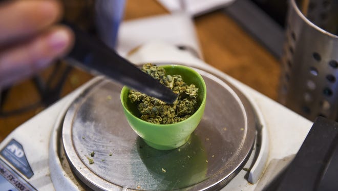 Marijuana is weighed at a dispensary in Fort Collins on Sept. 16.