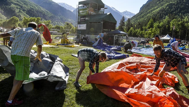 Festival attendees rush their tarps onto the field to claim a good spot during the Tarp Run in Telluride. The Tarp Run is a tradition of the Bluegrass Festival.
Festival attendees rush their tarps onto the field to claim a good spot as they participated in the "tarp run," Friday, June 19, 2015, in Telluride, CO. The "tarp run" is a tradition of the Bluegrass Festival, with many people waiting overnight in line.