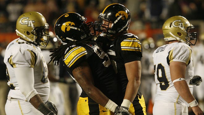Iowa defensive end Adrian Clayborn,left, had nine tackles and two sacks and was named the 2010 Orange Bowl's most outstanding player.