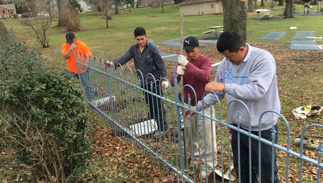 Workers from Long Fence out of Chantilly, start assembling a new fence at Gypsy Hill Park on Thursday, Feb. 4, 2016.