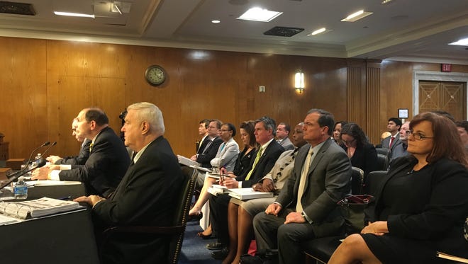 Germaine Clarno, right, watches as VA Secretary Bob McDonald testifies at a Senate hearing March 10, 2016.