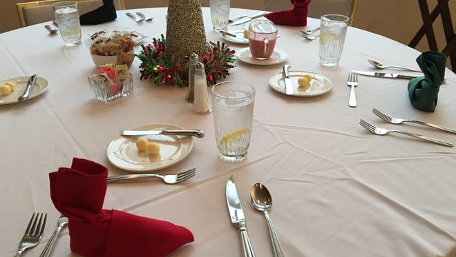 Diners in the Founders Room at the Spencer Theater Wednesday found their napkins folded into little Elf shoes. Spencer staffer Miranda Romero worked the magic.