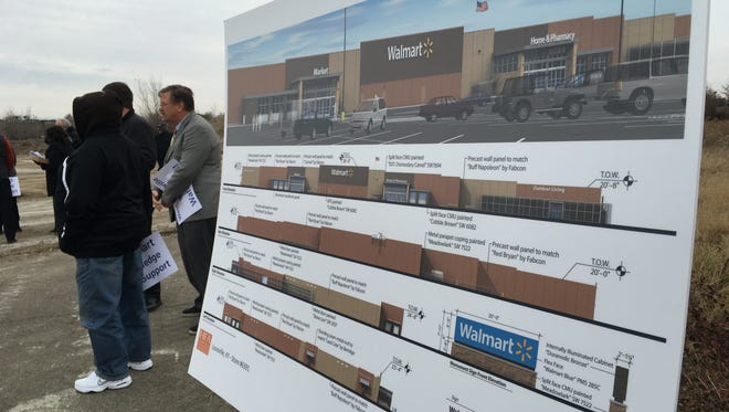 A poster shows plans for the abandoned West End Wal-Mart superstore. Supporters gathered at the proposed site to promote a petition asking Wal-Mart to reconsider. Dec. 5, 2016.