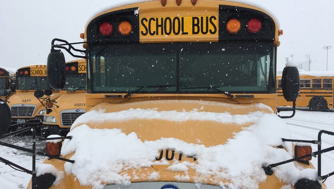 School buses are parked, covered with snow, at Reed High School in Reno on Thursday, Jan. 12, 2017.