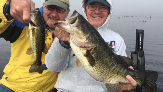 John Wason (right), with the big trophy bass, and his friend, Dick Slansky (left), spent Super Bowl Sunday morning catching Okeechobee bass on shiners with Capt. Mike Shellen of Okeechobeebassfishing.com.