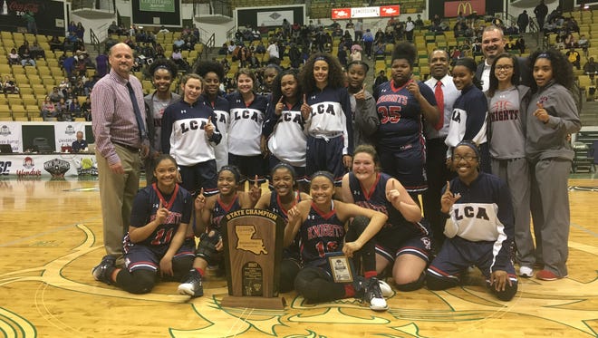 The Lafayette Christian Lady Knights pose with the state championship trophy after their 54-46 against Houma Christian in the Division IV state title game Friday afternoon.