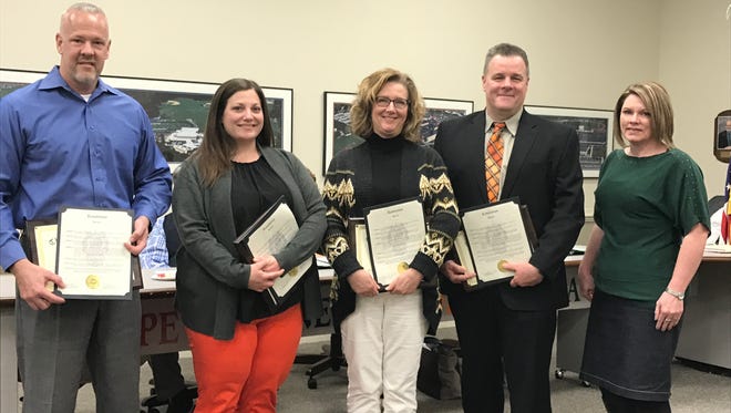 Cherokee High staffers Gary Denelsbeck (from left), Karen Hengst, Felicia Progar and Jeff Wood are shown with board member Bonnie J. Olt (right). The four staff members were honored at a board meeting on March 15 for the role they played in saving a colleague's life after a cardiac event.