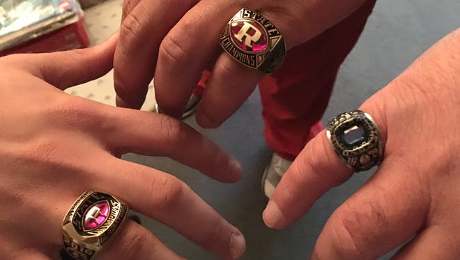 Jeff Shuey and his sons, Forrest Shuey and Travis Callison, show their football championship rings. Jeff Shuey, right, won his in 1979 with Parry McCluer. Travis Callison, middle, won his with the 2006 Riverheads team, while Forrest Shuey won his this past fall at Riverheads.